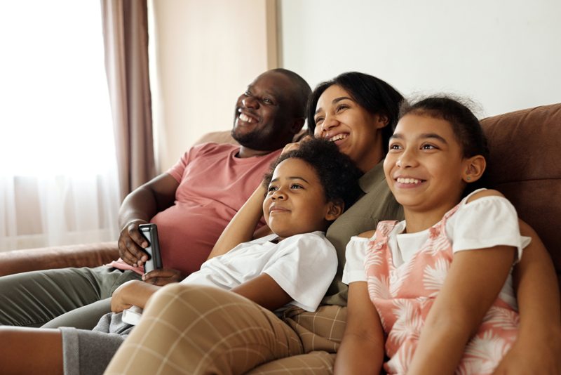 Happy family relaxing watching television